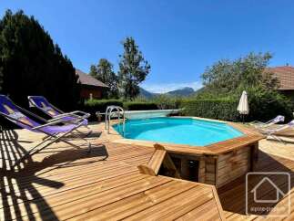 Enjoy the ultimate relaxation in this stunning property featuring a private pool and a spacious wooden deck.