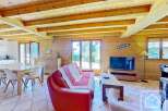 This charming property boasts a warm and inviting interior with exposed wooden beams and paneling, creating a cozy atmosphere.
