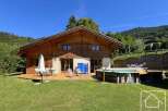 Discover your dream alpine retreat! This stunning property boasts a charming wooden exterior, a spacious deck perfect for entertaining, and a refreshing pool for those warm summer days.
