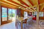 Experience the charm of this stunning property, featuring a spacious dining area with a large wooden table, perfect for gatherings.