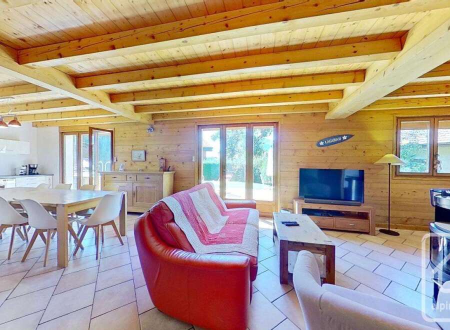 Discover the charm of this cozy property, featuring a warm wooden interior and a spacious living area.