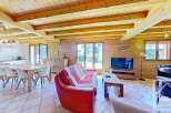 Discover the charm of this cozy property, featuring a warm wooden interior and a spacious living area.