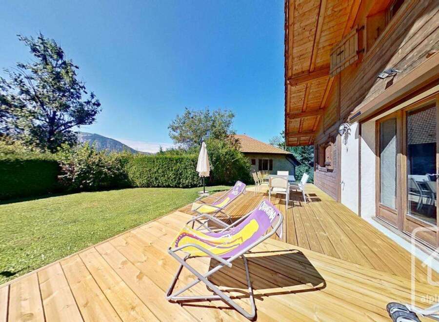 Enjoy the tranquility of this stunning property with a spacious wooden deck, perfect for relaxation and outdoor gatherings.