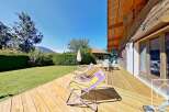 Enjoy the tranquility of this stunning property with a spacious wooden deck, perfect for relaxation and outdoor gatherings.