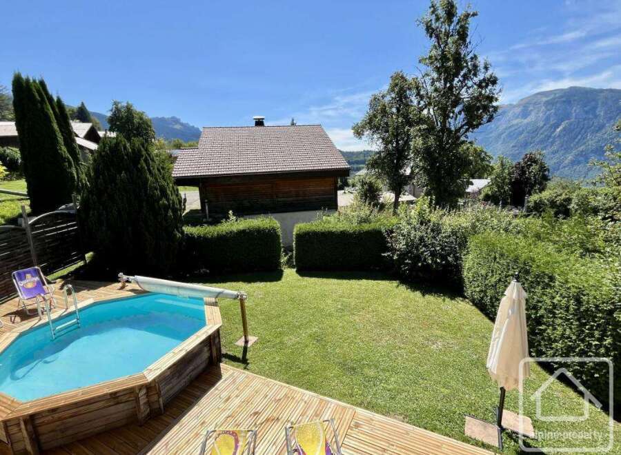 Enjoy the tranquility of this stunning property featuring a private pool and lush green surroundings.