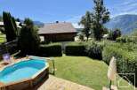 Enjoy the tranquility of this stunning property featuring a private pool and lush green surroundings.