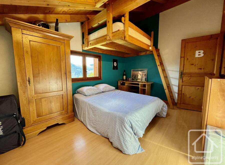 Discover this charming property featuring a cozy bedroom with a unique loft bed design.