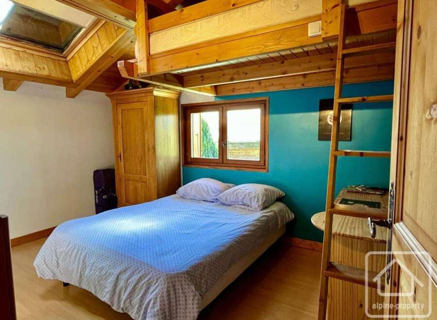 This charming bedroom features a cozy loft bed, perfect for maximizing space.
