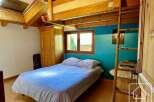 This charming bedroom features a cozy loft bed, perfect for maximizing space.