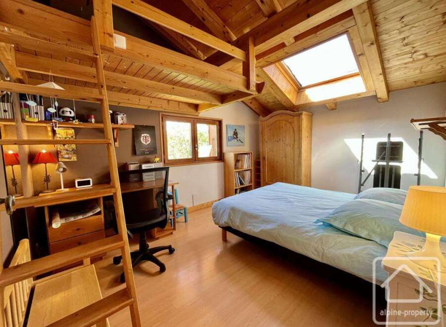 Discover the charm of this cozy bedroom, featuring a unique loft design and a skylight that floods the space with natural light.