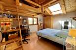 Discover the charm of this cozy bedroom, featuring a unique loft design and a skylight that floods the space with natural light.