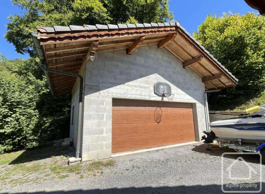 Discover this charming property featuring a unique garage with a basketball hoop, perfect for recreational activities.