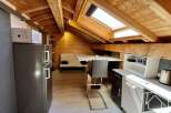 Discover the charm of this cozy apartment, featuring a unique wooden ceiling and a well-equipped kitchenette.