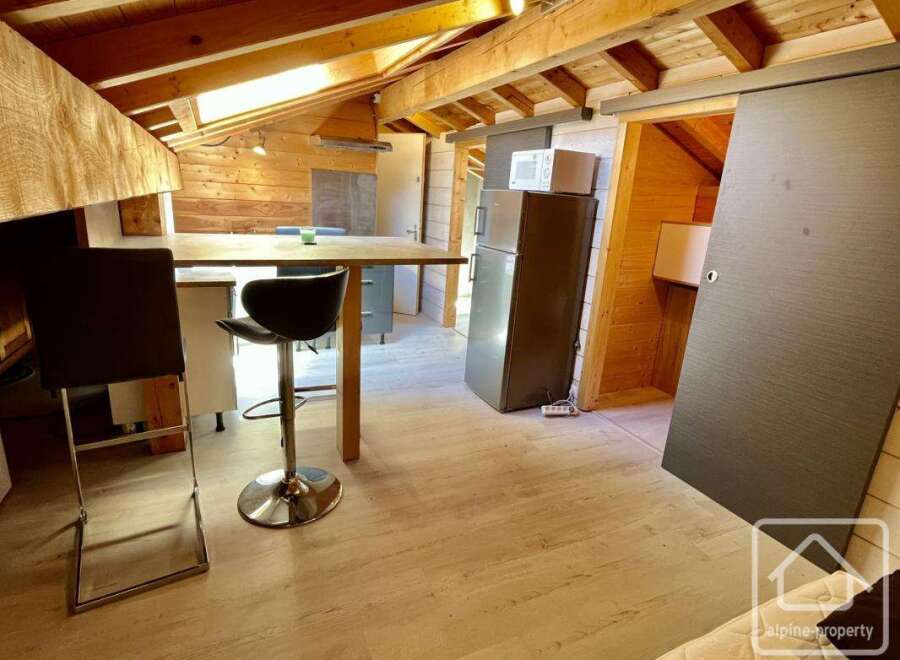 This charming property features a cozy interior with exposed wooden beams, creating a warm and inviting atmosphere.