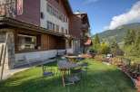 Nestled in a picturesque setting, this charming property boasts a traditional alpine design with wooden accents and a welcoming outdoor area.