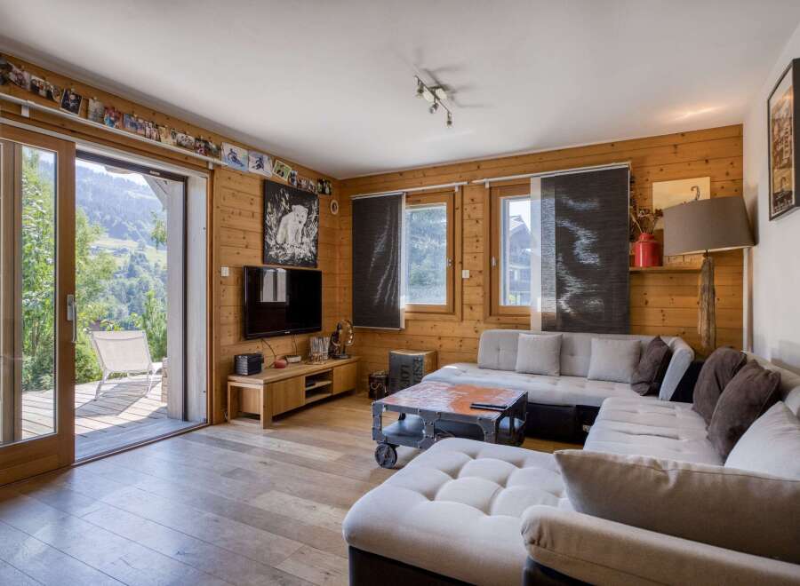 Step into a cozy living space with natural wood paneling and a stunning view.