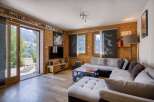Step into a cozy living space with natural wood paneling and a stunning view.
