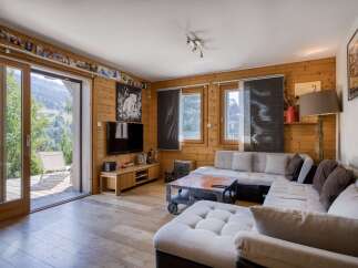 Step into a cozy living space with natural wood paneling and a stunning view.