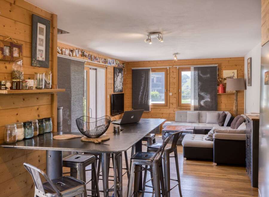 This cozy living space features beautiful wood paneling and a modern industrial design.