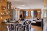 This cozy living space features beautiful wood paneling and a modern industrial design.