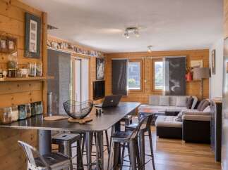 This cozy living space features beautiful wood paneling and a modern industrial design.