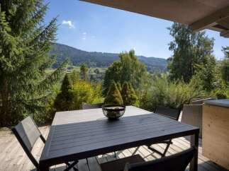 Enjoy breathtaking mountain views from this stunning outdoor dining area.