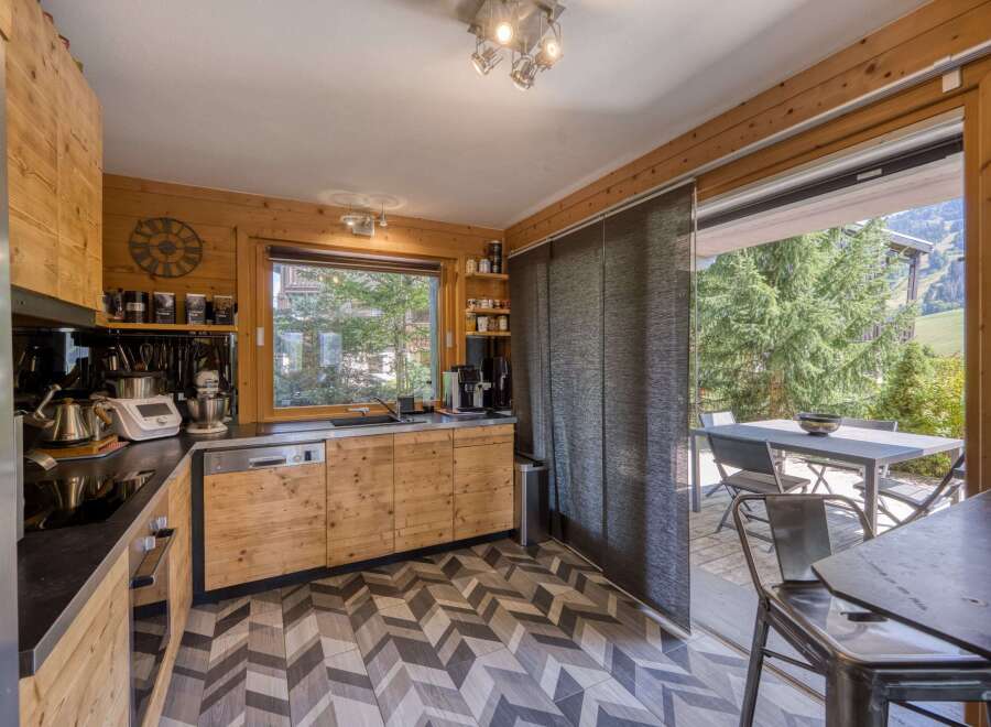 This stunning kitchen boasts a modern design with wooden cabinetry and a sleek countertop.