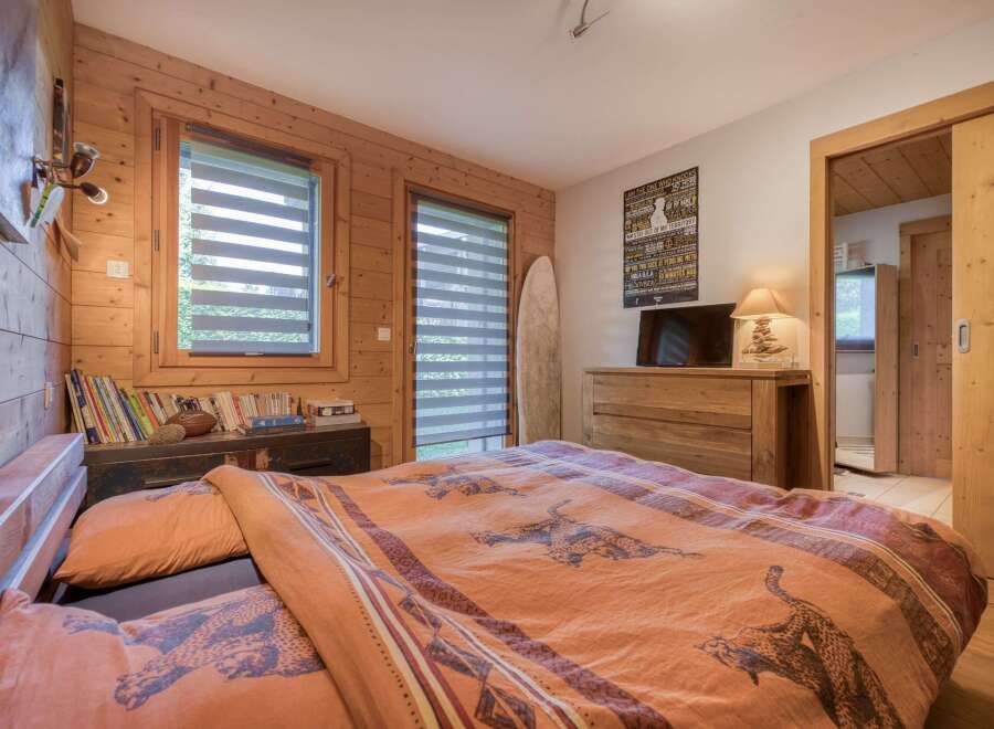 This cozy bedroom features a rustic wooden interior, creating a warm and inviting atmosphere.