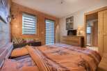 This cozy bedroom features a rustic wooden interior, creating a warm and inviting atmosphere.