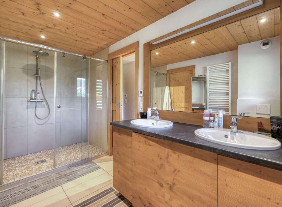 This stunning bathroom features a modern design with a touch of rustic charm.