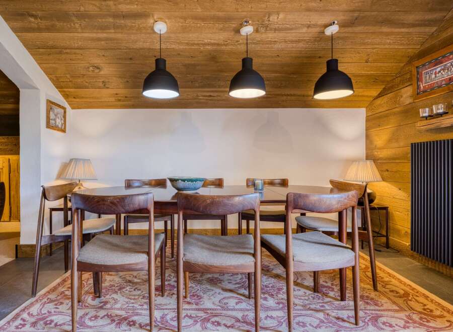 Step into this inviting dining room, featuring a warm wooden ceiling and walls that create a cozy atmosphere.