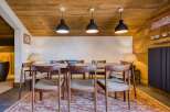 Step into this inviting dining room, featuring a warm wooden ceiling and walls that create a cozy atmosphere.