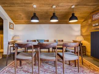 Step into this inviting dining room, featuring a warm wooden ceiling and walls that create a cozy atmosphere.