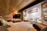 This cozy living space features a stunning wooden ceiling and walls, creating a warm and inviting atmosphere.