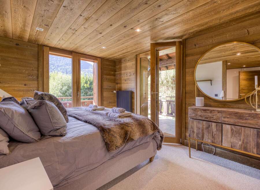 This cozy bedroom features a rustic wooden interior, creating a warm and inviting atmosphere.