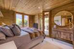 This cozy bedroom features a rustic wooden interior, creating a warm and inviting atmosphere.