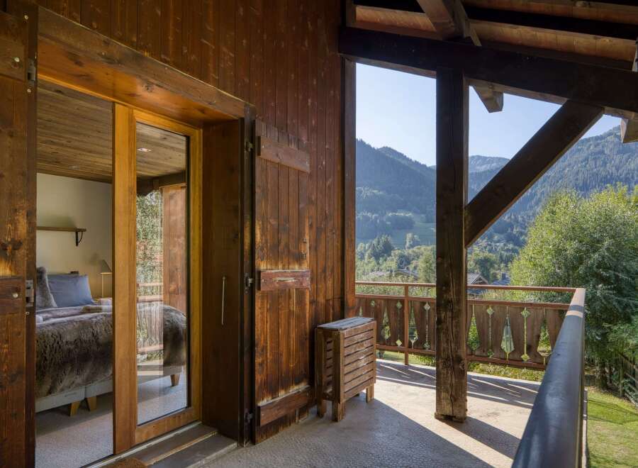 Experience the charm of this rustic property with its inviting wooden accents and stunning mountain views.