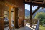 Experience the charm of this rustic property with its inviting wooden accents and stunning mountain views.