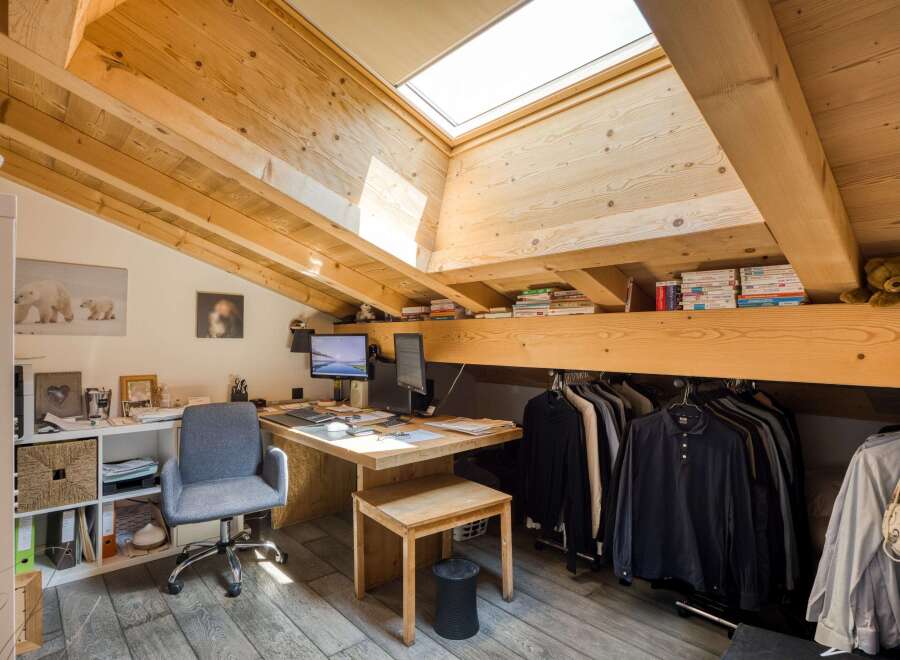 This charming attic space offers a unique blend of functionality and style, perfect for a home office or creative studio.