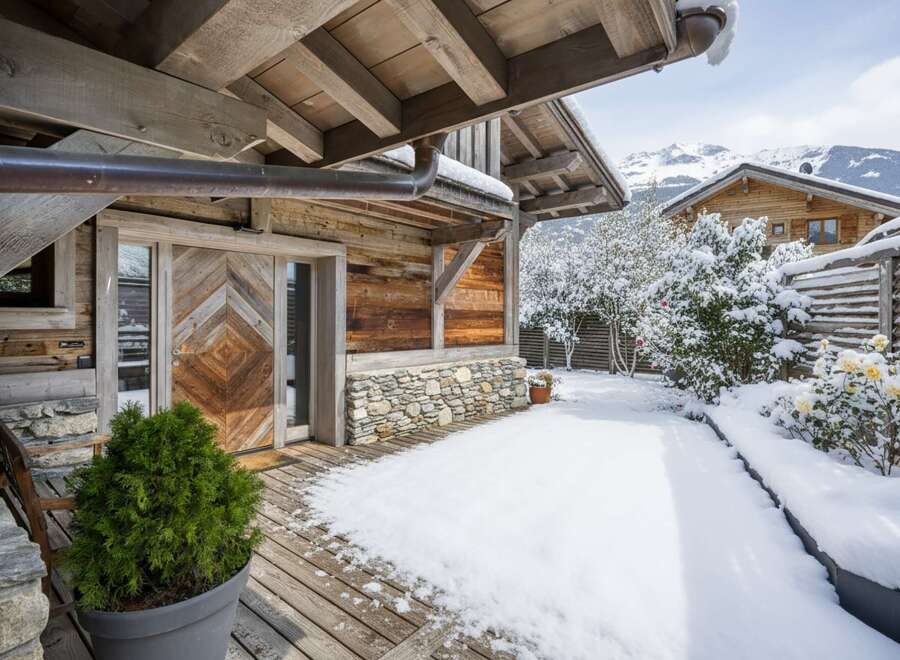 Experience the charm of this stunning wooden chalet nestled in a winter wonderland.
