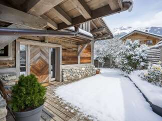 Experience the charm of this stunning wooden chalet nestled in a winter wonderland.