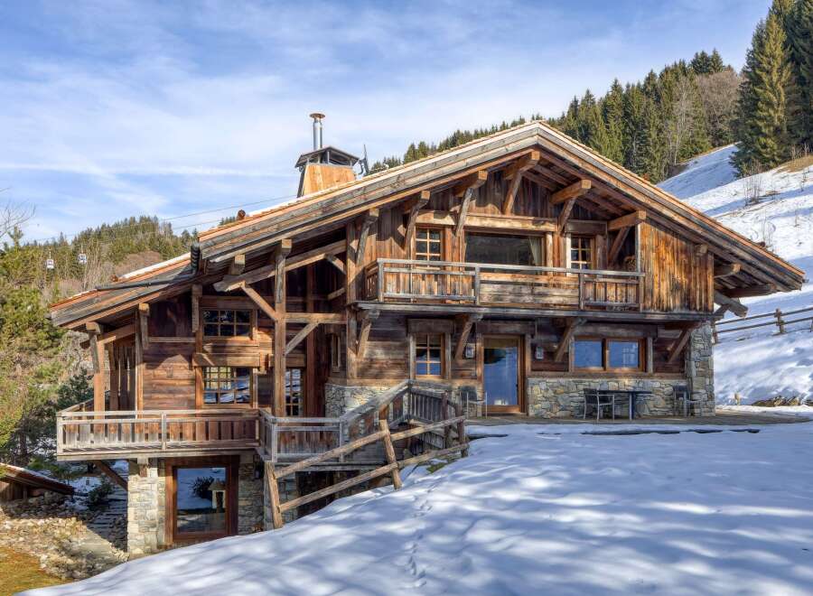 This stunning wooden chalet offers a luxurious mountain retreat with breathtaking views.