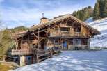 This stunning wooden chalet offers a luxurious mountain retreat with breathtaking views.