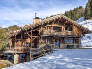 This stunning wooden chalet offers a luxurious mountain retreat with breathtaking views.