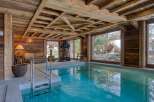This luxurious indoor pool area boasts a rustic, yet elegant design.