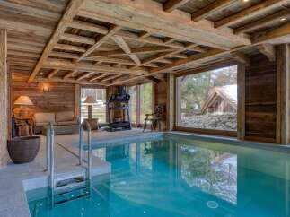 This luxurious indoor pool area boasts a rustic, yet elegant design.
