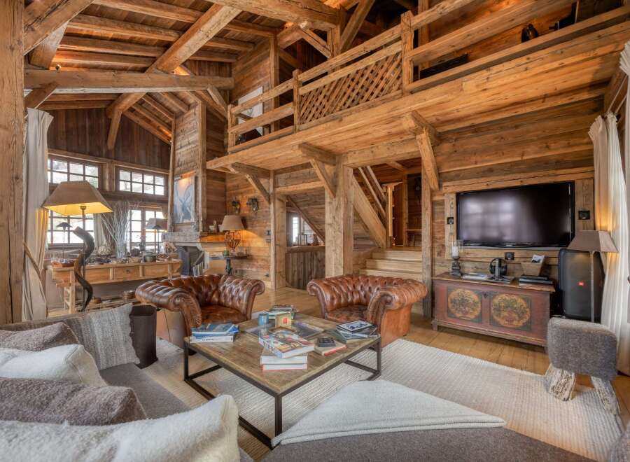 Experience rustic luxury in this stunning chalet, featuring exposed wooden beams and a cozy ambiance.