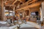 Experience rustic luxury in this stunning chalet, featuring exposed wooden beams and a cozy ambiance.