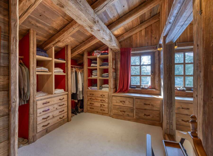 Step into luxury with this stunning walk-in closet, a perfect blend of rustic charm and modern elegance.