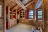 Step into luxury with this stunning walk-in closet, a perfect blend of rustic charm and modern elegance.